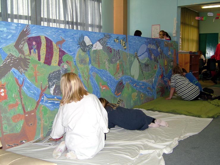 The Primary 6 and 7 children of Tarland School painting the River Dee Mural.